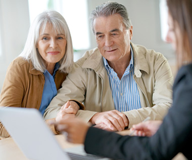 A senior couple reviewing their estate plan with an advisor